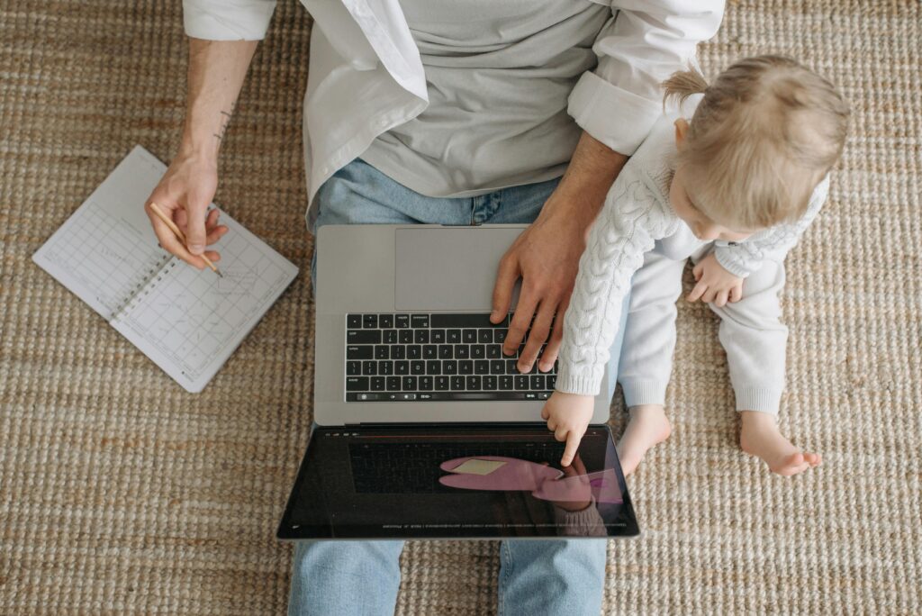 Father and child bonding over a laptop, enjoying togetherness and learning.